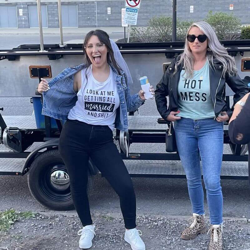 two girls with funny shirts at a bachelorette party