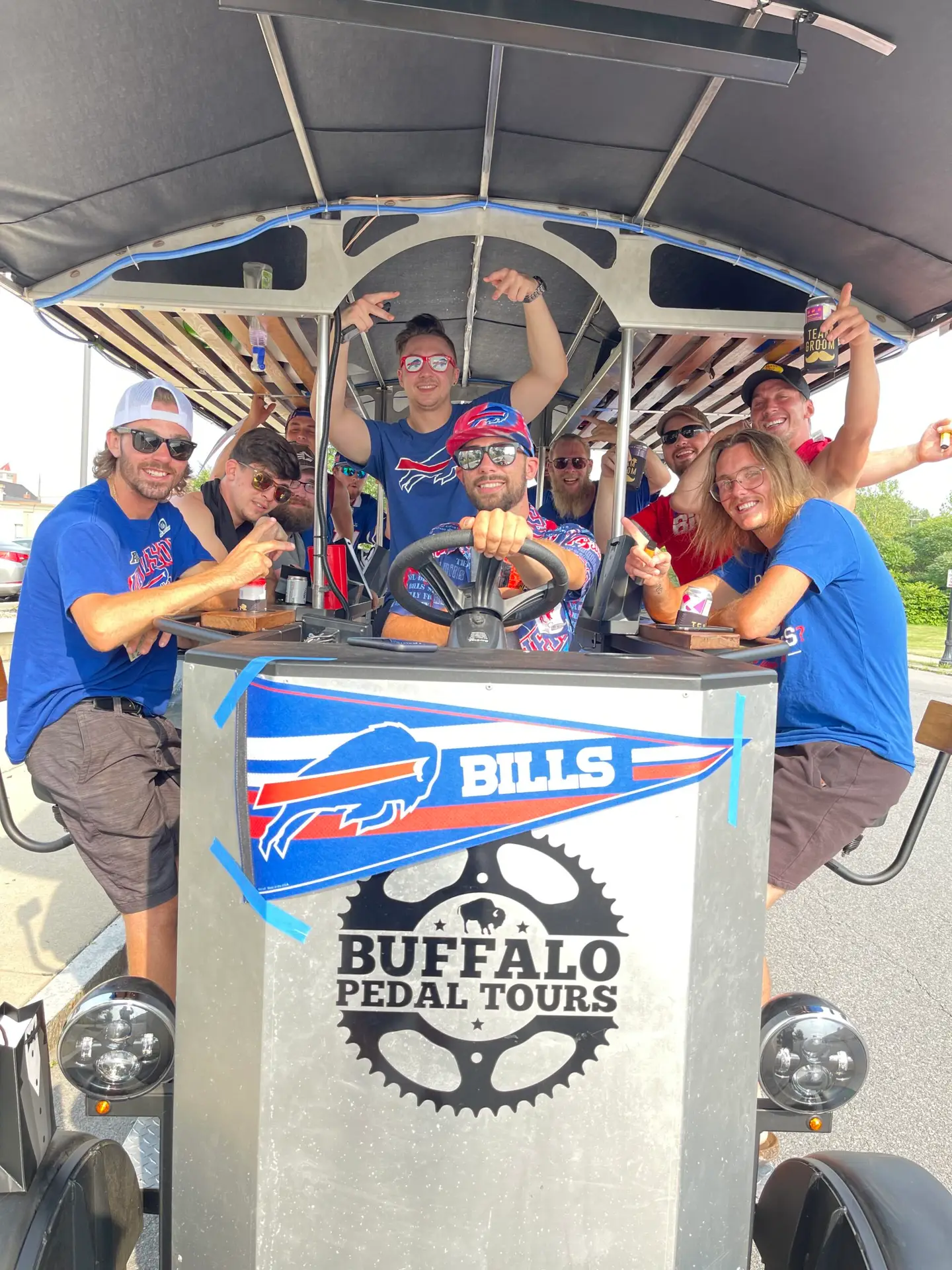 Lively bachelor party enjoying a Buffalo Pedal Tours pedal bike ride